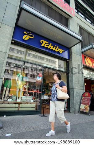 BERLIN, GERMANY - JUNE 11, 2014: A woman walks past a Tschibo coffee store in  Berlin, Germany, on Saturday, June 11, 2014