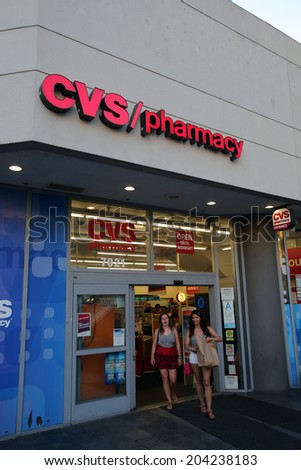 HOLLYWOOD, CALIFORNIA - TUES. JUNE 24, 2014: Pedestrians walk past a CVS drug store in Hollywood, California, on Sunday, June 29, 2014. CVS is the retail division of CVS Caremark