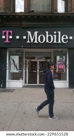 NEW YORK CITY - OCT. 20, 2014: Pedestrians walk past a T-Mobile retail store in New York City. T-Mobile is an international mobile communications company.