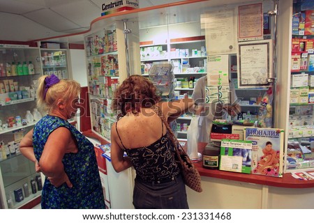 KIEV, UKRAINE - 16 AUGUST 2003: People wiat on line at a privately owned  pharmacy in Kiev, Ukraine.