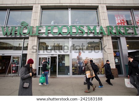 NEW YORK CITY - TUESDAY, DEC. 30, 2014: Pedestrians walk past a Whole Foods supermarket. Whole Foods Market, Inc. specializes in natural and organic foods.