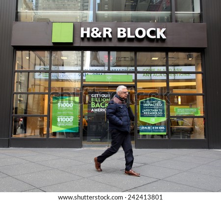 NEW YORK CITY - MONDAY, DEC. 29, 2014: Pedestrians walk past an office of H&R Block. H&R Block is a tax preparation company in the United States