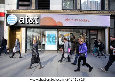NEW YORK CITY - MONDAY, DEC. 29, 2014: Pedestrians walk past an AT&T mobile telephone store. AT&T Mobility, formerly known as Cingular Wireless, is a wholly owned subsidiary of AT&T