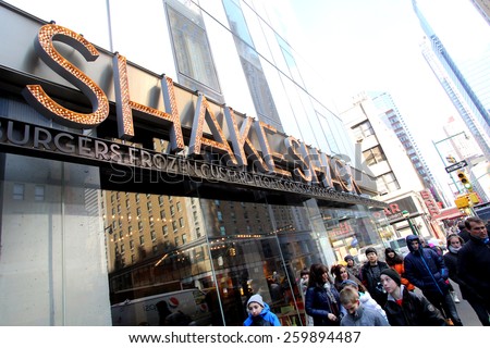 NEW YORK CITY - FEB. 25, 2015:  Pedestrians walk past a Shake Shack restaurant. Shake Shack is a fast casual restaurant chain based in New York City