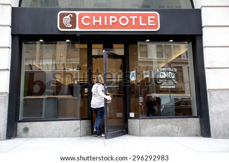NEW YORK CITY - FRIDAY, JUNE 19, 2015: Pedestrians walk past a Chipotle fast food restaurant. Chipotle Mexican Grill, Inc. is a chain of restaurants