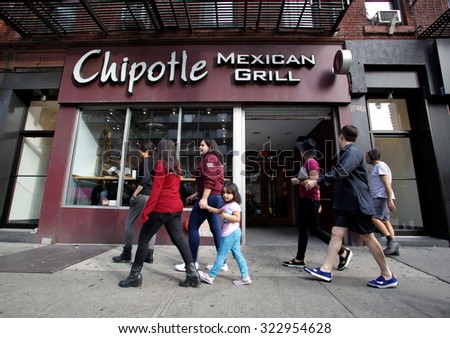 NEW YORK CITY - TUESDAY, SEPTEMBER 22, 2015: Pedestrians walk past a Chipotle Mexican fast food restaurant.  Chipotle Mexican Grill, Inc. is a chain of restaurants.