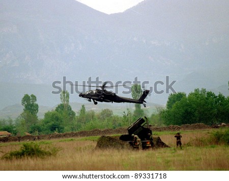 RINAS, ALBANIA -  21 APRIL: An United States  Army soldier watches the arrival of six U.S. Army Apache helicopters at a NATO-controlled airport outside the Albanian capital Tirana on April 21, 1999.