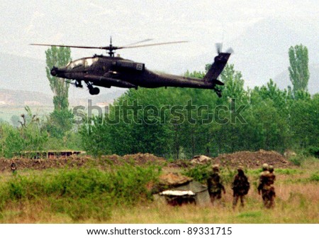 RINAS, ALBANIA -  21 APRIL: An United States  Army soldier watches the arrival of six U.S. Army Apache helicopters at a NATO-controlled airport outside the Albanian capital Tirana on April 21, 1999.