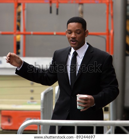 NEW YORK CITY - APRIL 15: Actor Will Smith starts singing to his coffee cup on the set of Men In Black 3 (MIB3) which is being filmed in New York, NY on April 15, 2011.