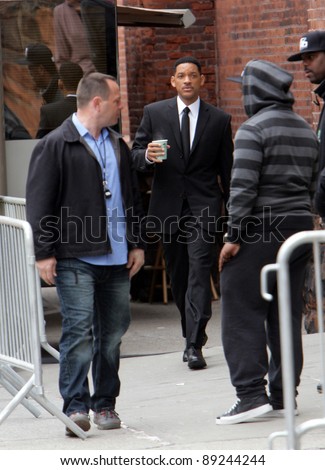 NEW YORK CITY - APRIL 15: Actor Will Smith carries a coffee cup on the set of Men In Black 3 (MIB3) which is being filmed in New York, NY on April 15, 2011.