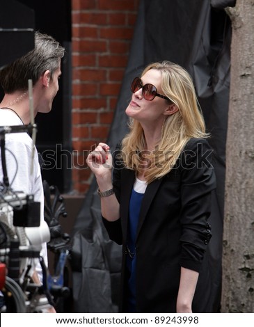 NEW YORK CITY - APRIL 15: Former SVU star Stephanie March (R) admires a tattoo on the arm of a crew member on the set of \