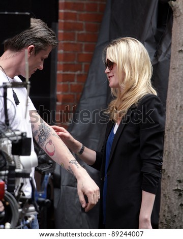 NEW YORK CITY - APRIL 15: Former SVU star Stephanie March (R) admires a tattoo on the arm of a crew member on the set of 