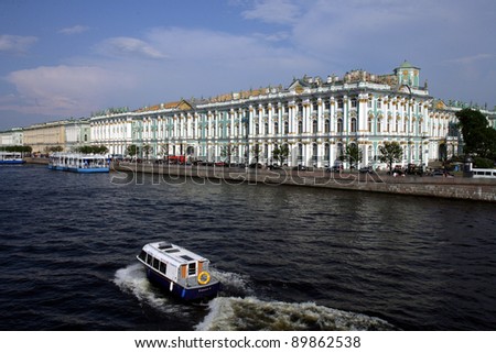 SAINT PETERSBURG, RUSSIA - JUNE 15: A tour boat on the River Neva in front of the Hermitage Museum in Saint Petersburg, Russia on Wednesday, June 15, 2011
