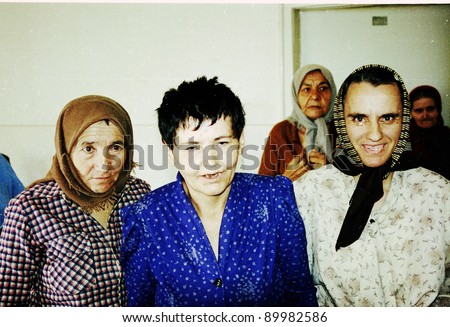 MOSTAR, BOSNIA - AUG 17: Women patients at a psychiatric institute take cover from machinegun fire during fierce fighting between Bosnian Muslim and Bosnian Croatian forces in Mostar, Bosnia, on Tuesday, August 17, 1993.