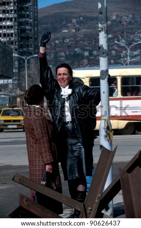 SARAJEVO, BOSNIA - MARCH 15: A Bosnian woman waves to friends across a no-man\'s land in Sarajevo. The city has been under siege by Bosnian Serb forces for nearly 3 years on Mar 15, 1996 in Sarajevo, Bosnia.