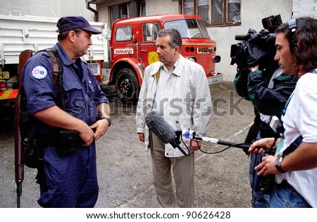 SARAJEVO, BOSNIA - APRIL 19: BBC chief war correspondent Martin Bell interviews a US volunteer firefighter in the Bosnian capital. Bell is now a member of the British parliament on Apr 19, 1996 in Sarajevo, Bosnia.