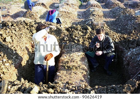 SARAJEVO, BOSNIA - JAN 15: Workers dig fresh graves in the shadow of the 1984 Winter Olympic stadium at the Lion cemetery in Sarajevo, Bosnia, on Monday, January 15, 1993.