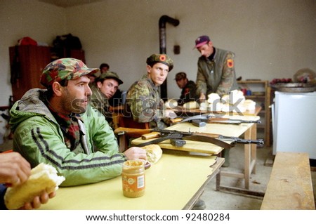 RETMILJE, KOSOVO - NOVEMBER 10: Soldiers of the Kosovo Liberation Army (KLA) eat peanut butter at a KLA regional HQ and barrack  in the Drenica Triangle on Nov 10, 1998 in Retmilje, Kosovo