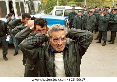 MOSCOW - SEPTEMBER 17: Men from Russia's Caucuses arrive at a police station after being arrested as part of a search for those behind deadly bombings which have claimed nearly 300 lives on September 17, 1999 in Moscow