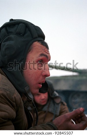 GUDERMES, CHECHNYA - JANUARY 16: Russian army armor troops try to keep warm, and catch a few minutes rest between fighting Chechen rebels on January 16, 2000