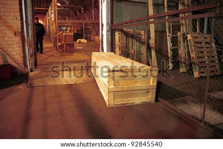 MOSCOW - JANUARY 17: A railway worker at Moscow\'s Yaroslavsky station retrieves a coffin containing the body of a Russian soldier killed last week in Chechnya identified only as Gavrikov, A.A on January 17, 2000 in Moscow