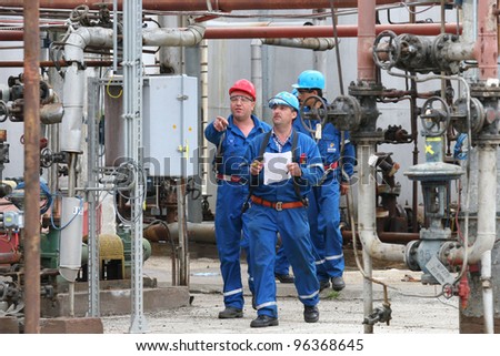 BUCHAREST, ROMANIA - NOV 9: Oil workers perform maintenance duties at the Arpechim refinery near Pitesti; on Nov 9, 2007 some 120 kilometers from Bucharest, Romania.