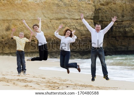 Family jumping on a beach