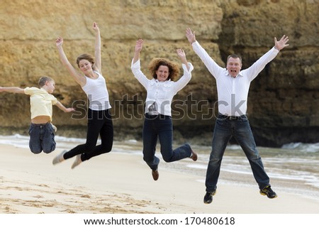 Family jumping on a beach