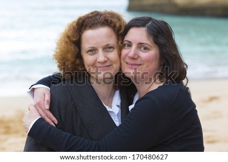 Best friends hugging on a beach