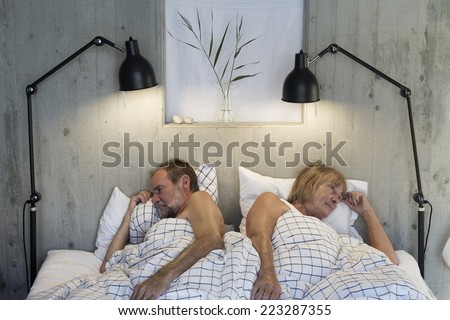 Older couple in bed angry