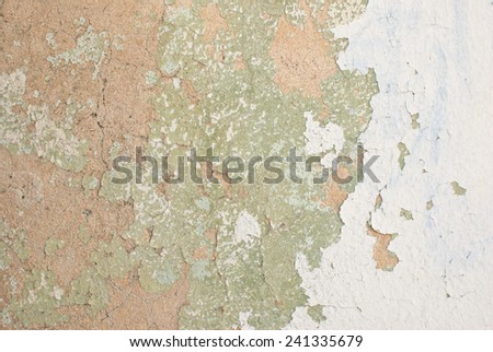 Flaking old rendered tan light green white cream painted wall