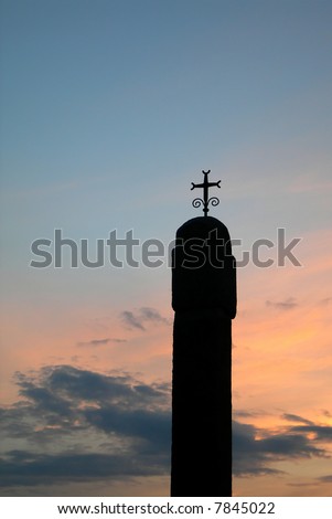 Old chapel with Cross silhouette at sunset
