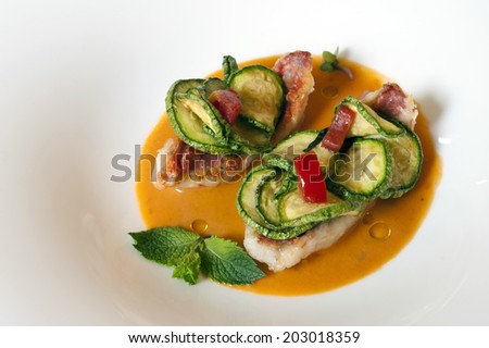 Crispy pan-fried mullet filet on tomato gaspacho served with a mint flavored zucchini ratatouille