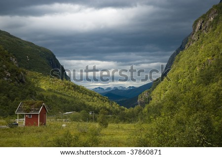 Norwegian landscape with red cabin, beautiful light conditions