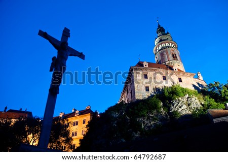 Jesus on cross and castle in Cesky Krumlov, UNESCO site