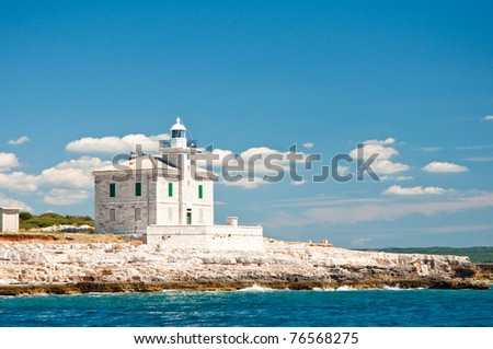 historical stone lighthouse on the seashore