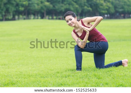 beautiful Asian woman practicing yoga nature in the park