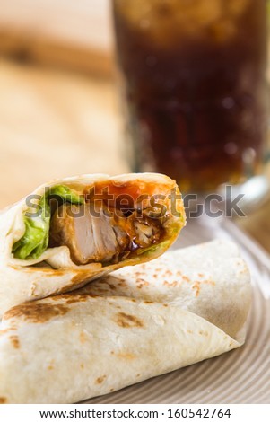 Closeup of kebab in a pancake with vegetables