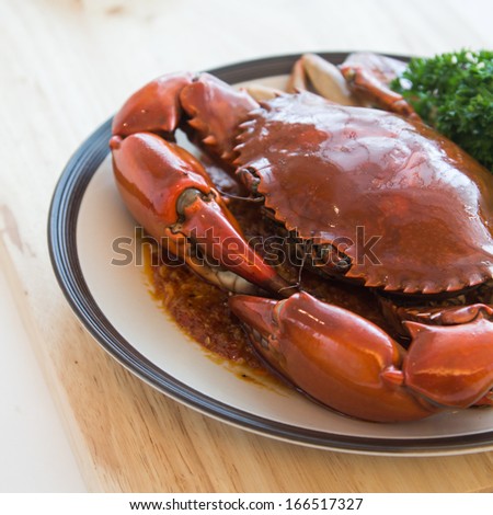 a dish of big crab stir chili decorated with parsley, Asian cuisine