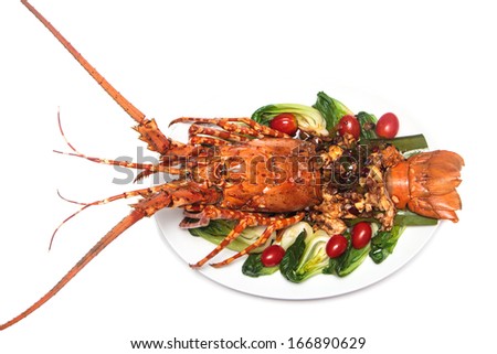 a luxury dish of lobster decorated with vegetables.