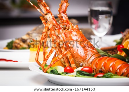 A Luxury Dish Of Lobster Roasted And Decorated With Many Items Of Vegetable