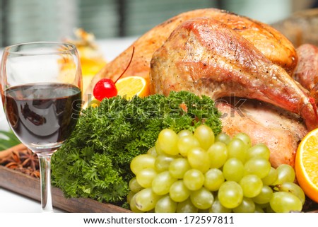 roasted chicken served with fruit and vegetable on wooden tray
