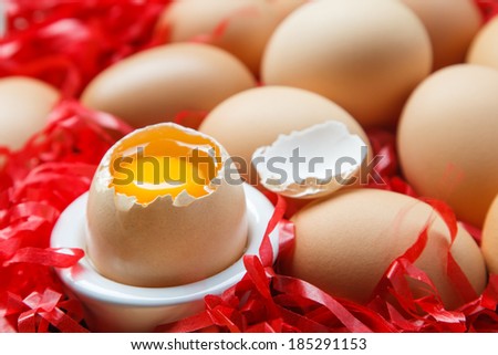 fresh brown eggs and one eggs is broken in cup