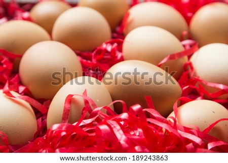 fresh brown eggs and one eggs is broken on tray