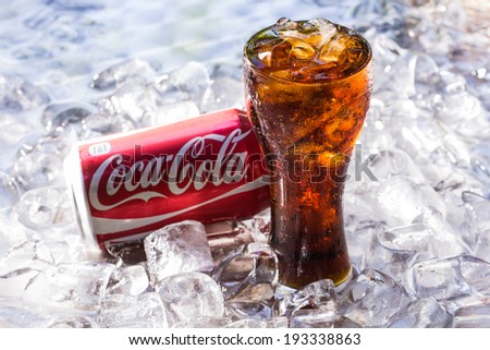 BANGKOK, THAILAND - MAY 8, 2014 : Can of Coca-Cola lying on ice. Coca-Cola is the one of the worlds favourite soft drinks.