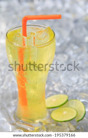 Lemon juice glass and fresh lemons. Isolated on ice background