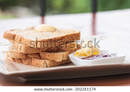 sliced bread with jam and butter
