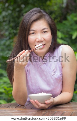 Beautiful young women  are eating rice in restaurant