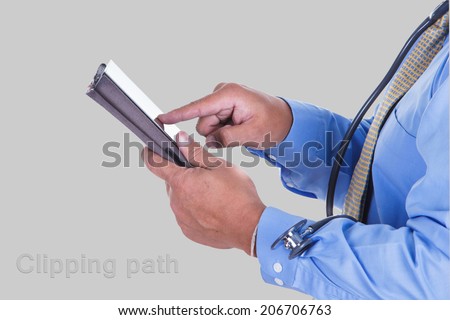 Senior doctor using his tablet computer at work with clipping path