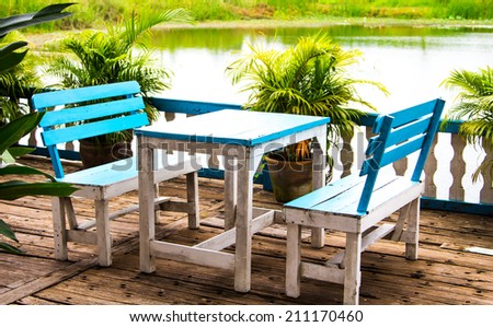 Table and Wooden Chair on the terrace by the river.